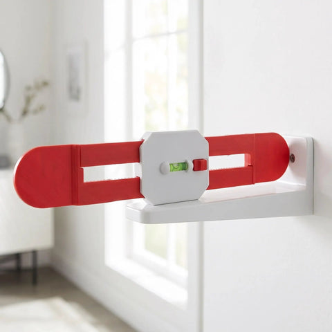 Telescopic Spirit Level for Air Conditioner Indoor Unit Installation with red arms and green bubble level against a wall.