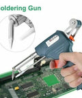 The Automatic Handheld Soldering Gun Kit with Desoldering Pump being used on a PCB for home DIY electronics repair.