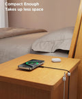 Nightstand with 9 Pack Magnetic Cable Clips For Easy Cable Management Under Desk And On Walls, holding a phone charging cable