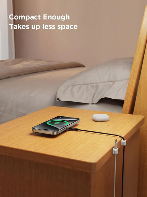 Nightstand with 9 Pack Magnetic Cable Clips For Easy Cable Management Under Desk And On Walls, holding a phone charging cable