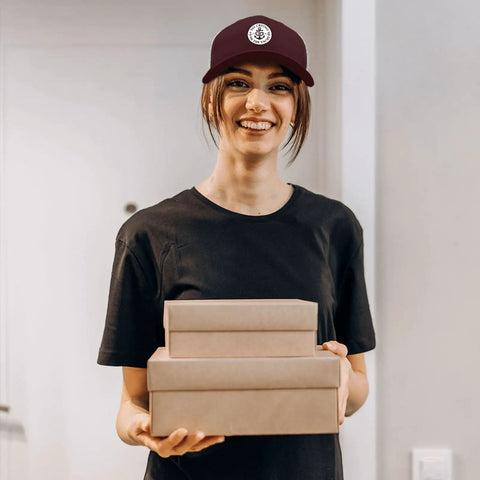 Smiling person wearing Breathable Yacht Style Trucker Hat For Women And Unisex, Lightweight All Day Comfort With Anti Sweat Band.