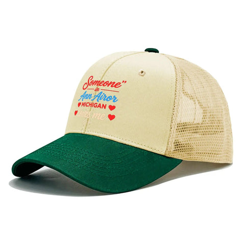 Lightweight Womens Sports Trucker Cap with low profile front, airy mesh ventilation eyelets, and sweat-wicking band in beige and green