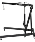 Heavy Duty Folding Engine Hoist And Cherry Picker Shop Crane With Six Smooth Rolling Caster Wheels and hydraulic lift, black metal frame.