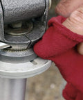 Red gloved hand using 150 Pack Cotton Shop Towels Rags 14x12 Inches Absorbent, Reusable Cleaning Rags For Auto Shops on machinery.