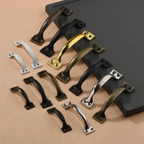 Assorted door pulls on display, featuring Vintage Five Inch Door Pulls 2 Pack Bow Shaped Gate Handles In Red Bronze Finish