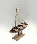 Norwegian Sailing Pram Model Kit 1:12 Scale For Adults, DIY Woodcraft Project displayed on a wooden stand