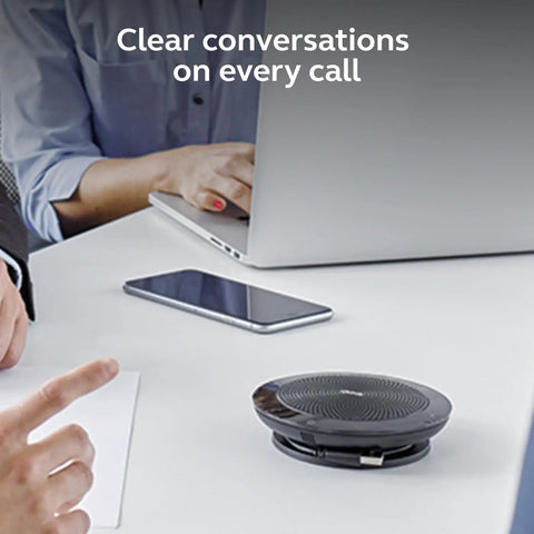 Speak 510 Portable Conference Speaker For Meetings And Calls With Rock Solid Sound USB Or Bluetooth Wireless Connectivity on a table during a meeting.