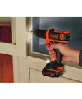 Using 12V Max Drill And Home Tool Kit 60 Piece Set With Compact Lithium Ion Drill Driver on cabinet.