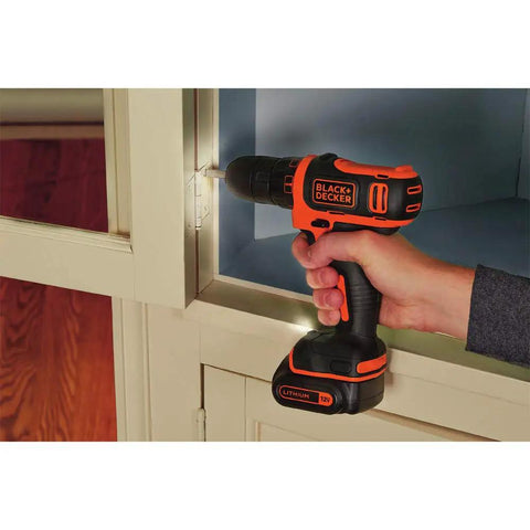 Using 12V Max Drill And Home Tool Kit 60 Piece Set With Compact Lithium Ion Drill Driver on cabinet.