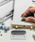 Badass Heavy Duty L Shape Drawer Lock Strike Plates Silver Metal Latch Fasteners For Cabinet Security Right Angle Iron Hardware To Secure Your Stash Premium Furniture Reinforcement Replacement Hardware For Dressers Desks And Cabinets Pack Of Twenty with hand installing.