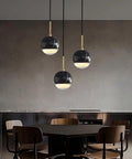 LTNANJE Modern LED Small Natural Stone Pendant Light Fixture with black marble design in dining room setting.