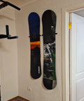 Beefy Ski And Snowboard Wall Mount Storage Rack Invisible Floating Garage Display Organizer securely holds two snowboards on the wall.