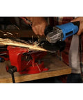 Person using 20V Lithium Ion Cordless Angle Grinder Built Like A Tank With An Adjustable Side Handle for cutting metal, sparks flying.