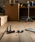 Close-up of screws, connectors, and a bracket on a wooden surface for 4 Pack Hydraulic Brake System Kit For Bikes With Olive Hose Connectors