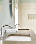 Glyde Chrome Two Handle High Arc Centerset Bathroom Faucet With Sleek Finish in a modern bathroom setting