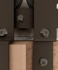 Close-up of metal components of the Beefy 11Ft Bypass Barn Door Hardware Kit For 66 Inch Double Doors with industrial grade steel.