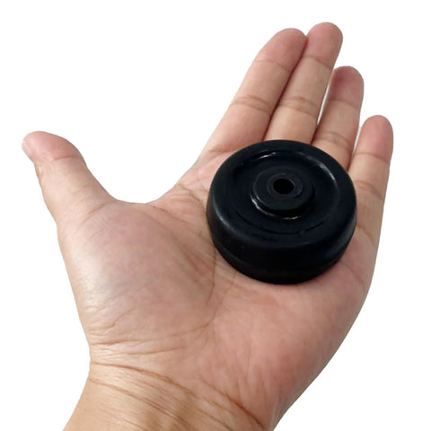 Hand holding a single 2 Inch Diameter Rubber Caster Wheel 50x25mm Bore 6.5mm Black for trolleys and carts.