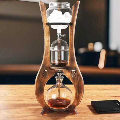 Skip The Store Bought Stuff And Sip Dope Flavor With This Portable Cold Brew Drip Tower Featuring Dual Adjustable Valves High Borosilicate Glass Large Capacity For Bold Iced Coffee on a wooden table