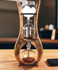 Kickstart Your Routine With This Cold Brew Drip Tower And Portable Iced Coffee Maker Featuring Dual Adjustable Valves For Custom Drip Rates Crafted From Durable Borosilicate Glass For A Smooth Daily Grind, displaying ice, coffee grounds, and brewed coffee.