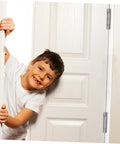 Child peeking through a door with heavy duty spring-loaded door hinges in stainless steel.