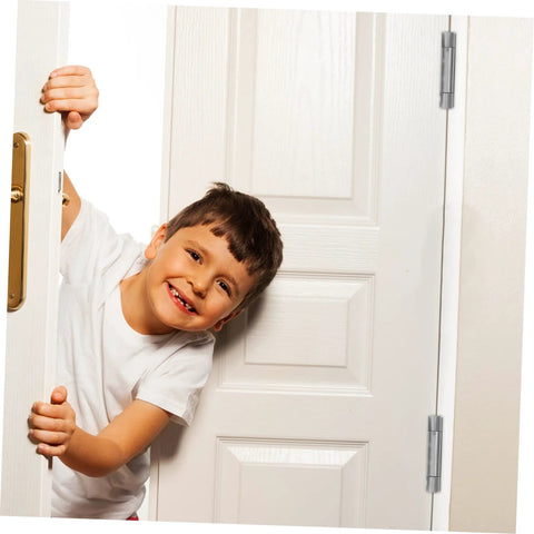 Child peeking through a door with heavy duty spring-loaded door hinges in stainless steel.