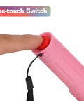 Finger pressing button on pink Pocket Size 9 LED Mini Flashlight Pack Six With Lanyards Multicolor Beams And 18 AAA Batteries Included