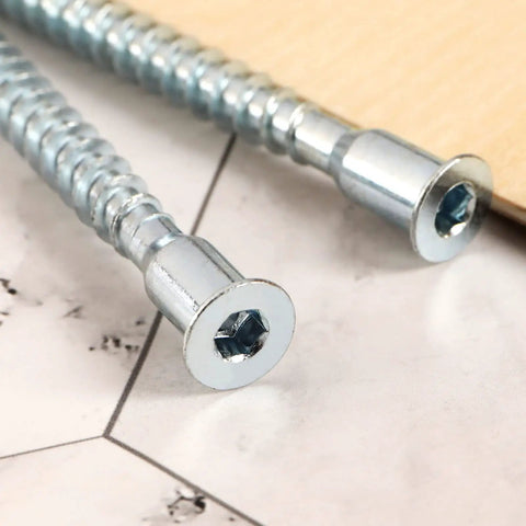 Close-up of M7x70mm hex socket countersunk self tapping furniture screws, flat head, carbon steel, zinc plated on marble surface.