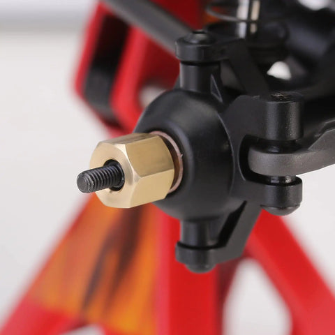 Close-up of Beefy Brass Wheel Hex Hub Extenders Six Millimeter And Two Millimeter Adapters for 1/18 Scale RC Crawler TRX4M Upgrade