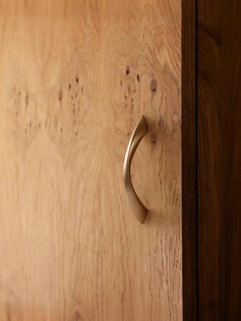 Champagne Bronze 3 Inch Arch Twisted Brass Cabinet Pulls on wooden cabinet door.