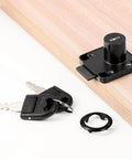 Gotta Keep Your Drawers Locked Down Tight With These Heavy Duty Three Pack Cabinet Locks Featuring Quick Folding Keys For Snappy Setups And Rock Solid Security On Dressers File Boxes And Doors In Black key and lock set on wooden surface.