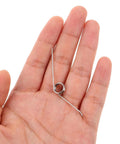 Hand holding silver metal torsion spring for trash can lid, Yardwe 16pcs Premium Trash Can Torsion Spring Replacement Kit For Kitchen Bin Lid Fix With Card Slot And Foot Pedal Integration Durable Silver Metal Parts For Quick Diy Repair And Home Upgrades.