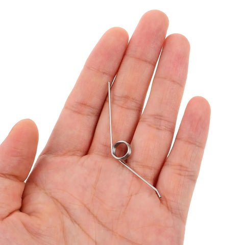 Hand holding silver metal torsion spring for trash can lid, Yardwe 16pcs Premium Trash Can Torsion Spring Replacement Kit For Kitchen Bin Lid Fix With Card Slot And Foot Pedal Integration Durable Silver Metal Parts For Quick Diy Repair And Home Upgrades.