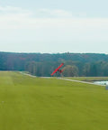 A red RC plane flies over a green field in Evolution RC Flight Simulator Software Only With Dope VR Headset Support Air And Heli.