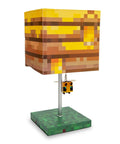 Pixelated Yellow Bee Nest Block Desk Lamp With 3D Bee Puller And LED Mood Light For Bedroom Desk Playroom Pixel Gaming Decor For Kids Room Nightstand Accent That Is Totally Lit, featuring a cube-shaped pixelated shade and a 3D bee pull ornament on a green base.