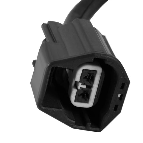 Close-up view of a black automotive two-pin electrical connector for a power brake booster vacuum pump, white insert visible