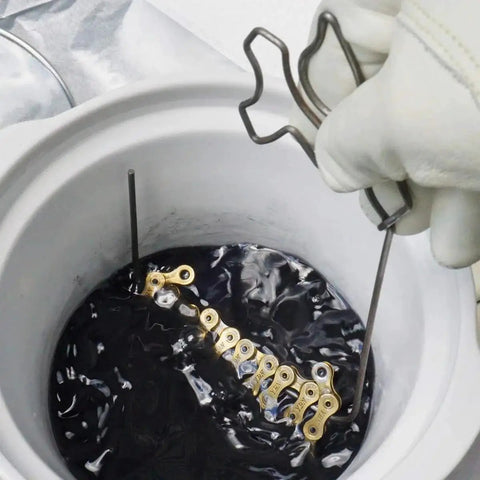 Bike Chain Wax Kit For All Conditions Keeps Your Drivetrain Slick No More Grease Marks Or Messy Cleaning Delivers Smooth Shifts And Peak Efficiency On Every Ride One Pound Bag in use, showing chain dipping in wax solution.