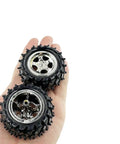 Hand holding 4 Pack Plastic Toy Car Wheels With Metal Shaft Axles For RC Cars Trucks And Robots DIY Model Projects 55mm Diameter