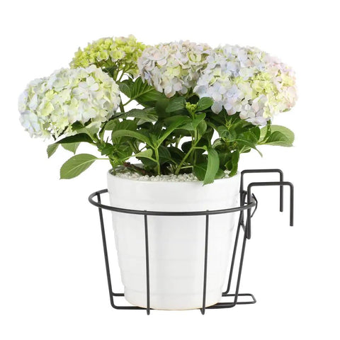 Front view of Three Pack 10 Inch Railing Planters For Balcony Or Porch Hanging Baskets Outdoor Indoor Flower Pot Holders Fits Up To Nine And A Half Inch Pots And Two And Three Quarter Inch Rail No Fuss Easy Hang Metal Fence Planters with white pot and flowers.