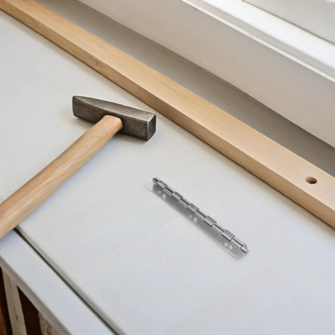 12Pcs Piano Hinges with Smooth Action for Cabinet Doors and Lids shown with hammer and wood plank on surface