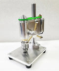 Mini Bench Drill Press For Precision Watchmaker Use With Variable Speed Control And 0.3 To 4mm Clamping Range  on metallic surface.