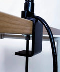 Close-up of black clamp for Ultra Bright LED Desk Lamp With Clamp and 24-Inch Flexible Gooseneck Arm on wooden desk edge