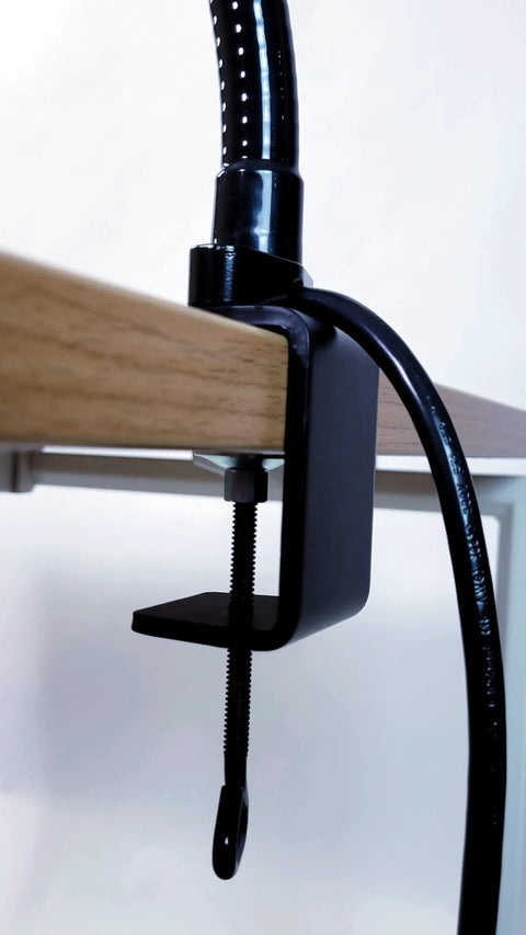 Close-up of black clamp for Ultra Bright LED Desk Lamp With Clamp and 24-Inch Flexible Gooseneck Arm on wooden desk edge