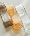 Three stylish glass light shades in brown, amber, and clear colors, ideal for Artpad 19.69‑Inch Modern Ceiling Pendant Light, LED Living Room Lighting.