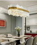 Slick Fresh Oval Glow Dimmable LED Pendant Light Adjustable Hanging Ceiling Fixture For Dining Room And Kitchen Top Shelf Gold Steel Chandelier above dining table with floral centerpiece.