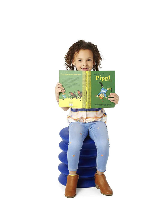 Child sitting on blue stool reading, similar to Active Sitting Stool for Kids Ergonomic Wiggle Friendly Desk Chair in orange for focus.