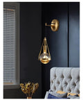 Slick Premium Copper LED Wall Sconce Featuring Glare Free Crystal Shade For Modern Bedroom Bedside Hallway And Staircase Decor With Tight Rust Proof Build And Killer Warm Ambient Glow - Wall-mounted, gold fixture beside a plush bed.