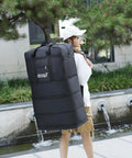 Travel duffel bag, side view: extra-large black Oxford fabric with wheels; expandable luggage.