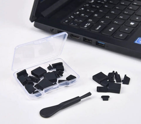 Ultimate USB Port Dust Plug Kit With 30 Silicone Caps and brush next to a laptop, showcasing USB, Micro USB, and iPhone port covers.