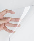 Close-up of hand holding a Clear PVC Desk Pad For Writing 23.6x13.7 Inches, Heat Resistant Waterproof Oil Proof Anti Static Desk Protector