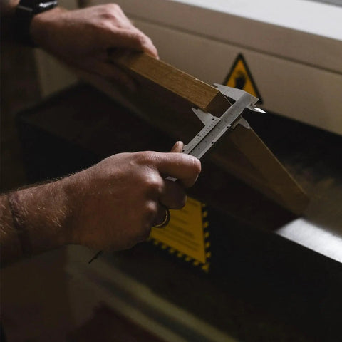 Person using 6 Inch Vernier Caliper Handy Non Digital Tool 0 to 6 Inch 0 to 150mm With 0.05mm Accuracy Carbon Steel on wood